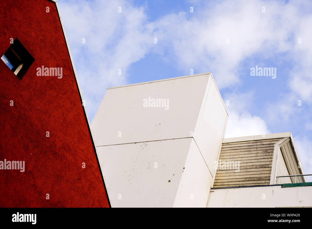 Close Up of Strong Building Shapes and Patterns Aganist a Blue Sky With Clouds Stock Photo