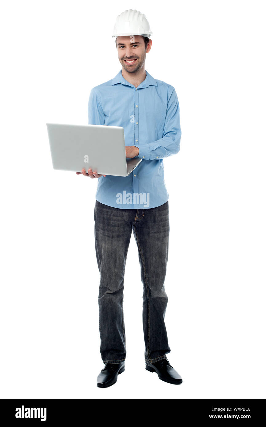 Male architect browsing on his laptop Stock Photo