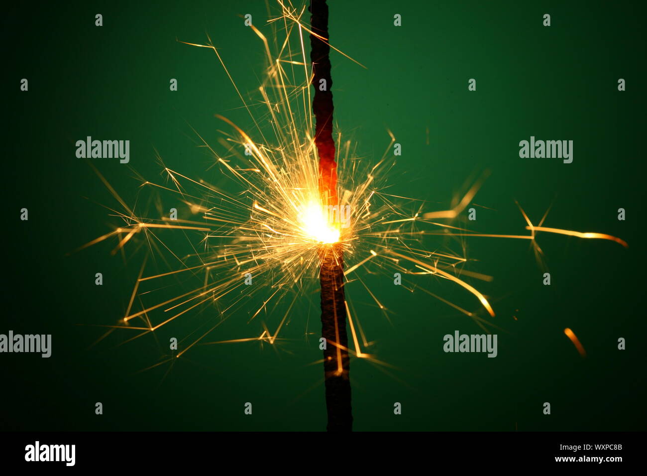 christmas sparkler on green background Stock Photo - Alamy