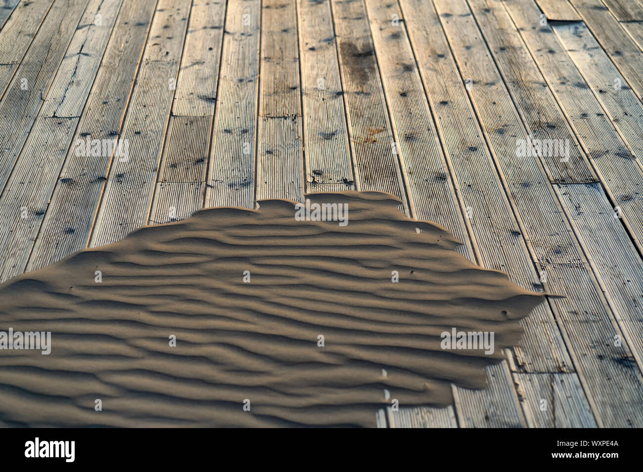 Sand on a wooden terrace on the beach Stock Photo