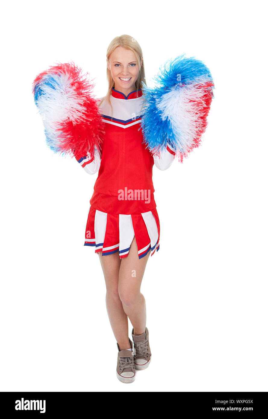 Smiling beautiful cheerleader with pompoms. Stock Photo