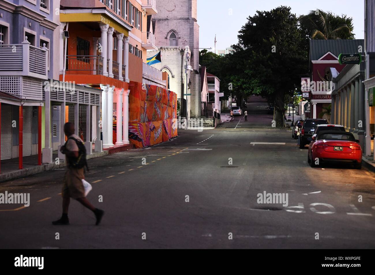 Nassau, Bahamas. 16th Sep, 2019. A man walks across the street days after Hurricane Dorian swept Nassau, capital of Bahamas, Sept. 16, 2019. Hurricane Dorian, a Category 5 storm, made a landfall on Elbow Cay in Abaco Islands in the Bahamas on Sept. 1. According to media reports, the list of missing as a result of Hurricane Dorian stands at an alarming 1,300 people and the death toll at 50. Credit: Xin Yuewei/Xinhua/Alamy Live News Stock Photo