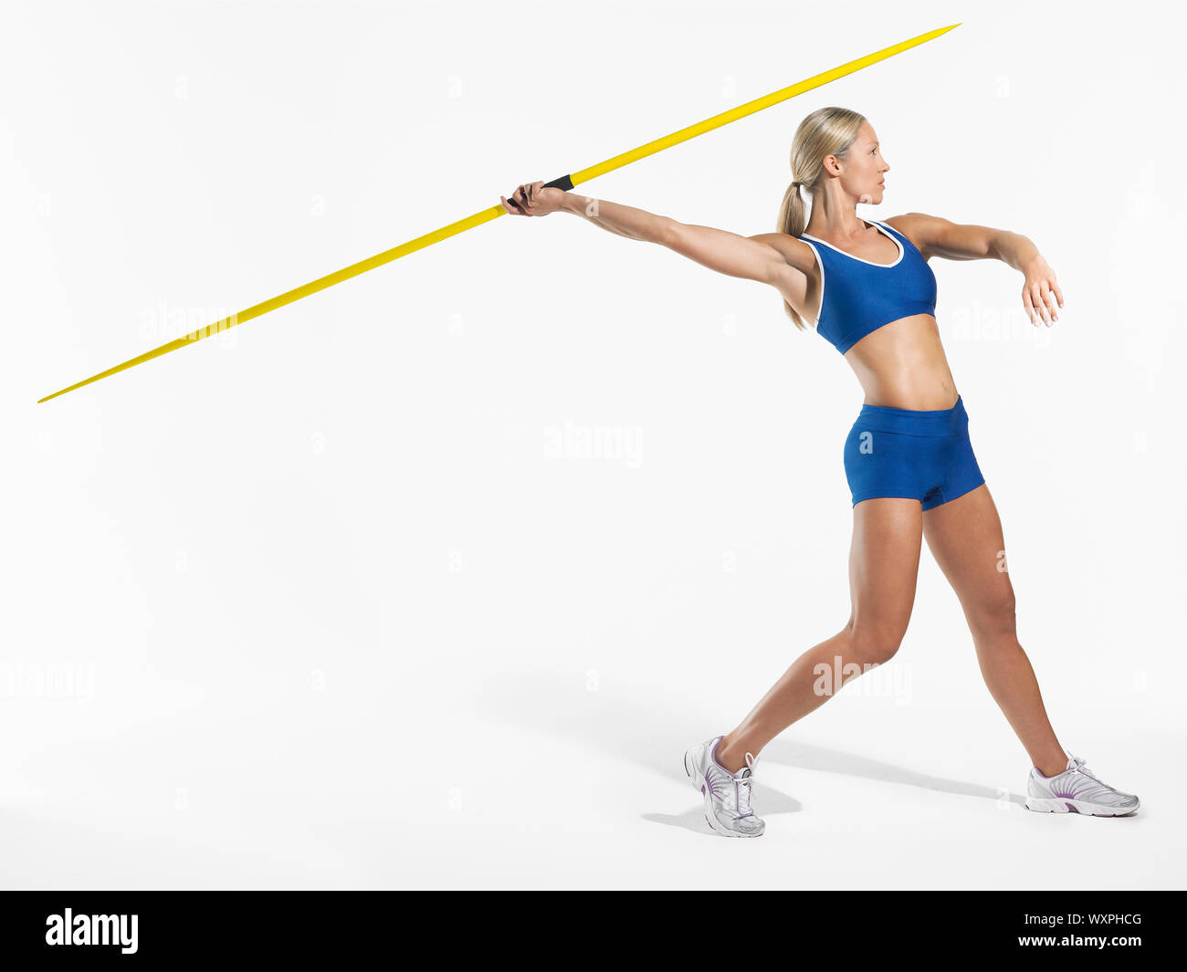 Full length side view of a female athlete preparing to throw javelin