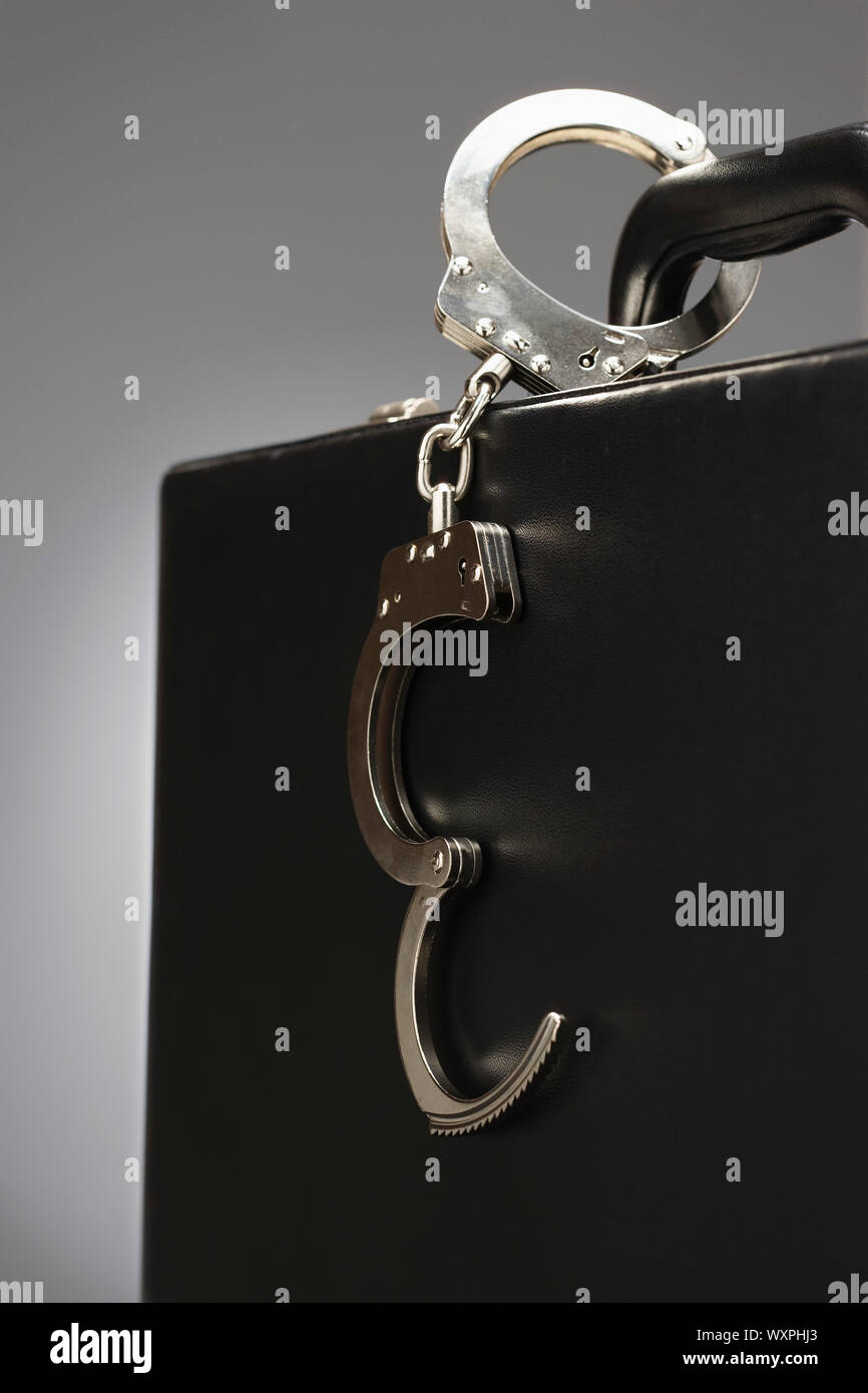 Handcuffs on a Briefcase Stock Photo Alamy