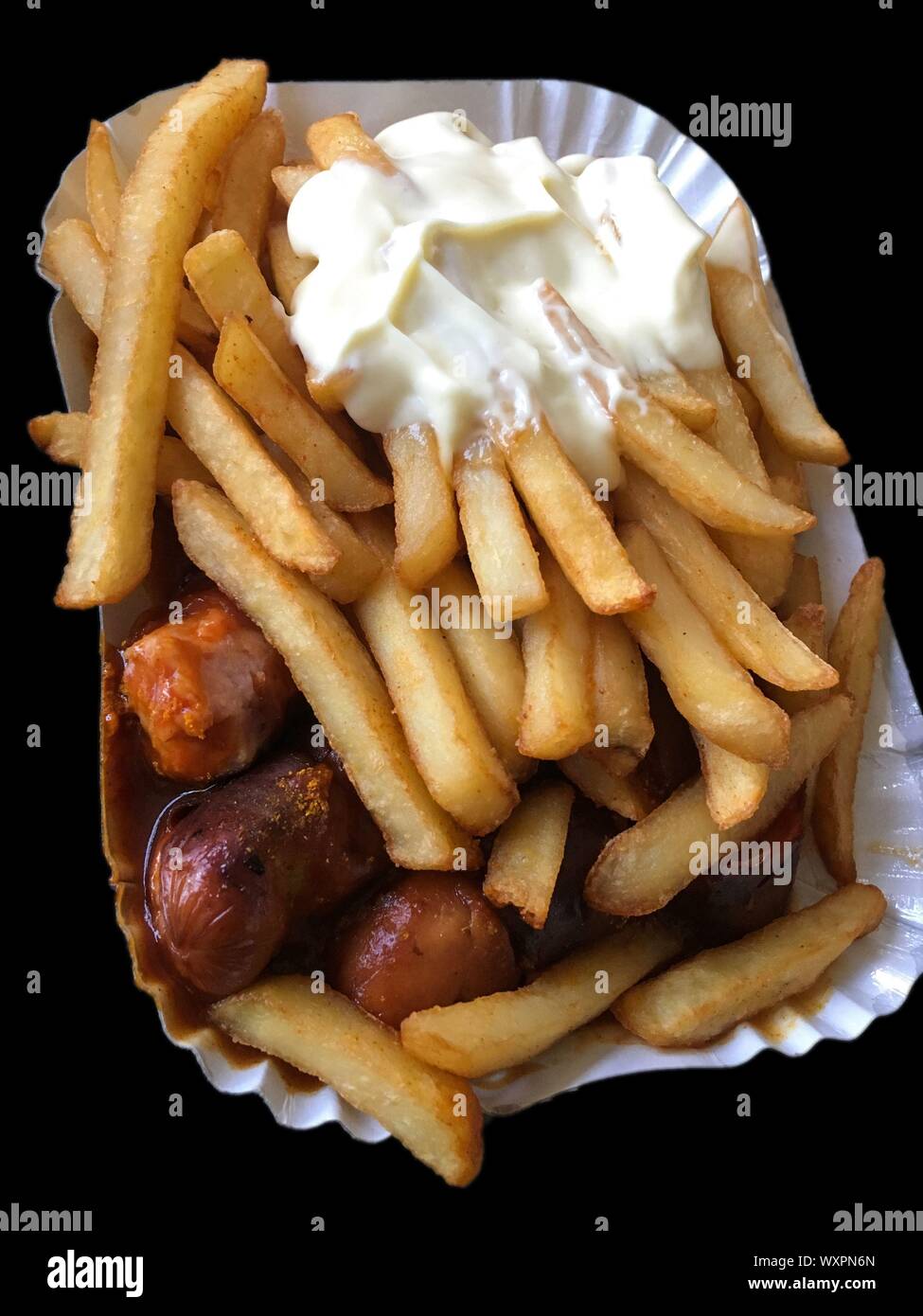 Currywurst & Pommes on black background: Famous German Fast Food (Curry Sausage with French Fries and Curry Sauce) with ketchup and mayonaise Stock Photo