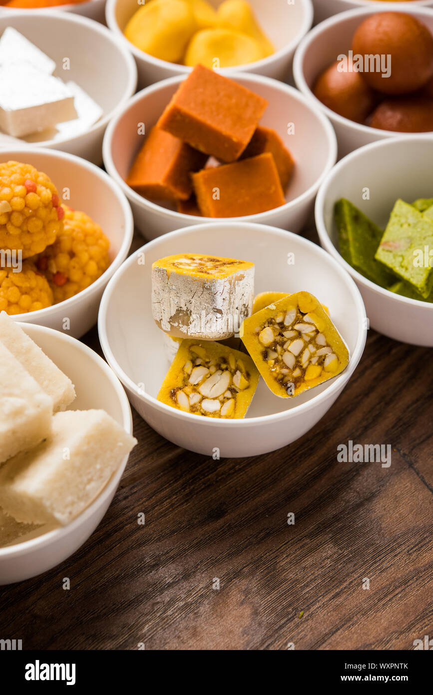 Snack Rangoli Rangoli of sweets and Farsan/snacks in bowls for Diwali with diya over ...