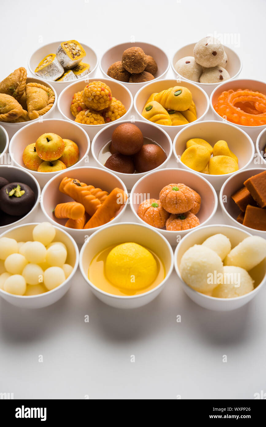 Snack Rangoli Rangoli of sweets and Farsan/snacks in bowls for Diwali with diya over ...
