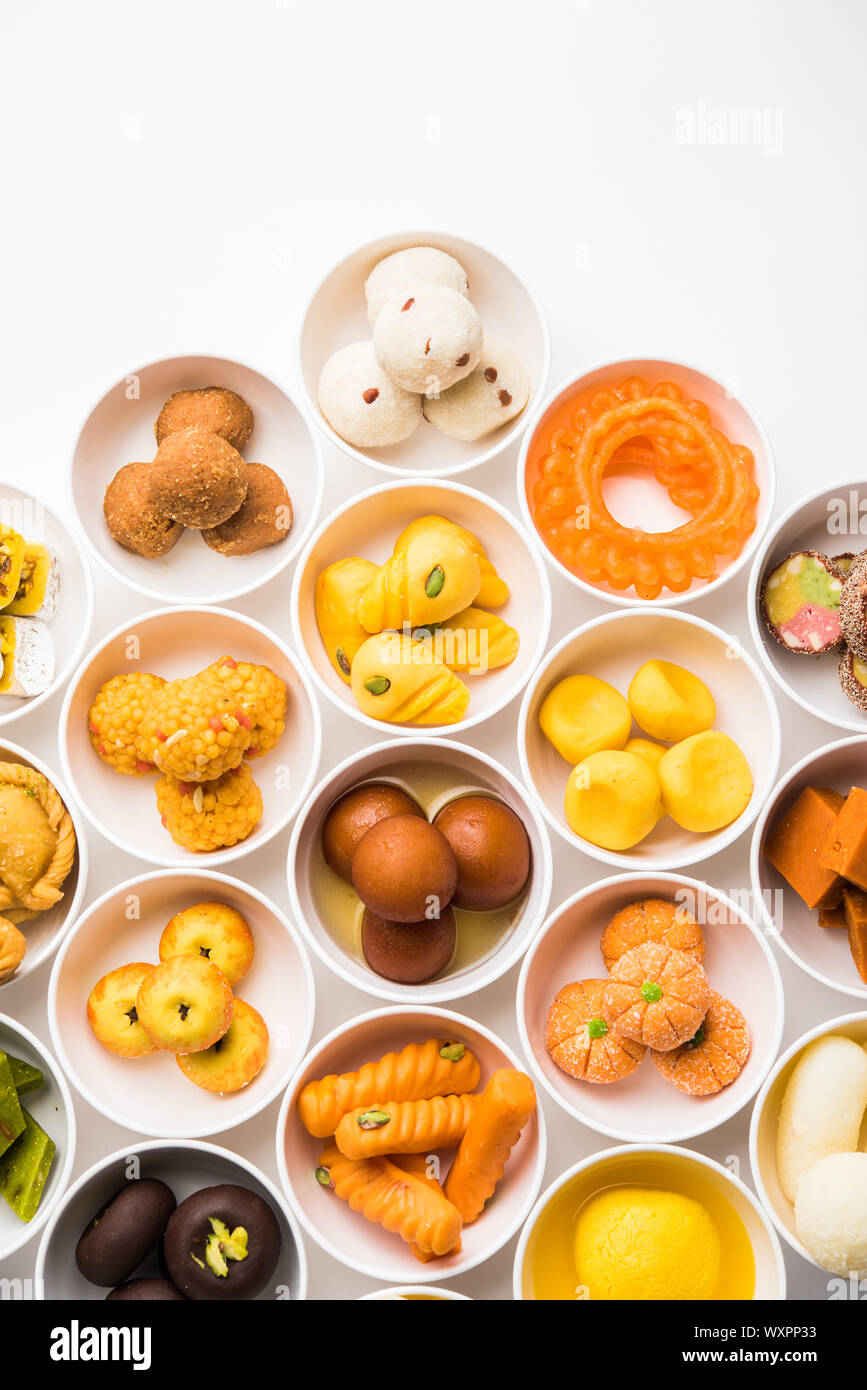 Snack Rangoli Rangoli of sweets and Farsan/snacks in bowls for Diwali with diya over ...