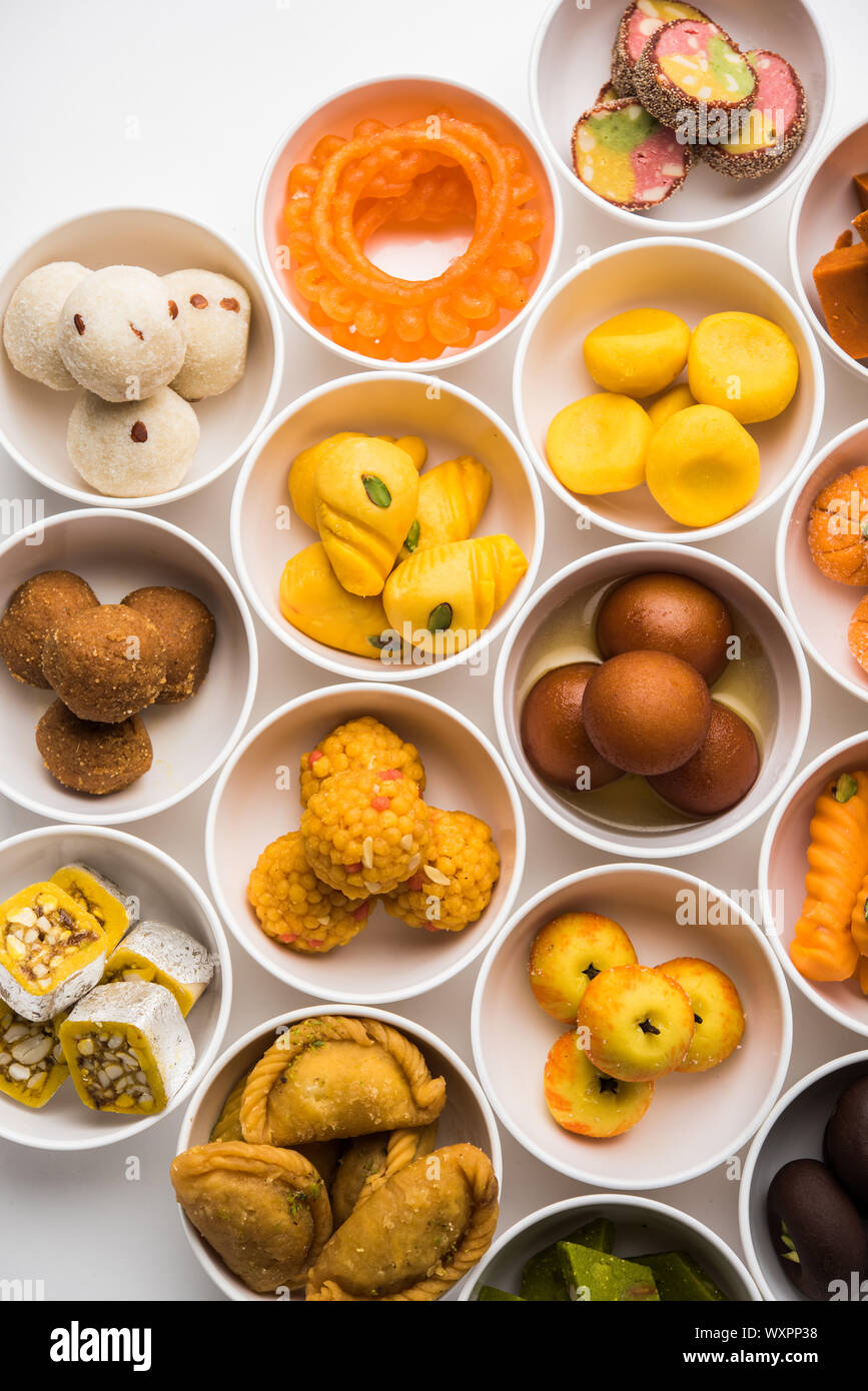 Snack Rangoli Rangoli of sweets and Farsan/snacks in bowls for Diwali with diya over ...