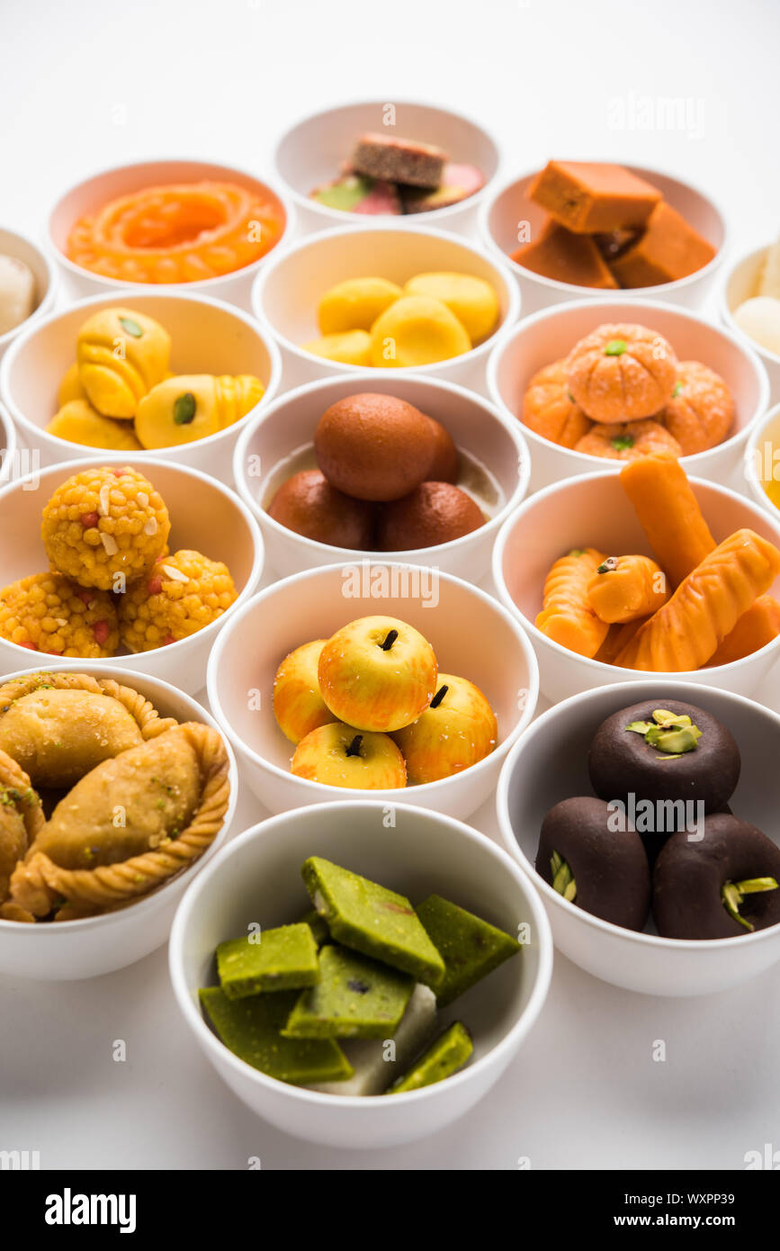 Snack Rangoli Rangoli of sweets and Farsan/snacks in bowls for Diwali with diya over ...