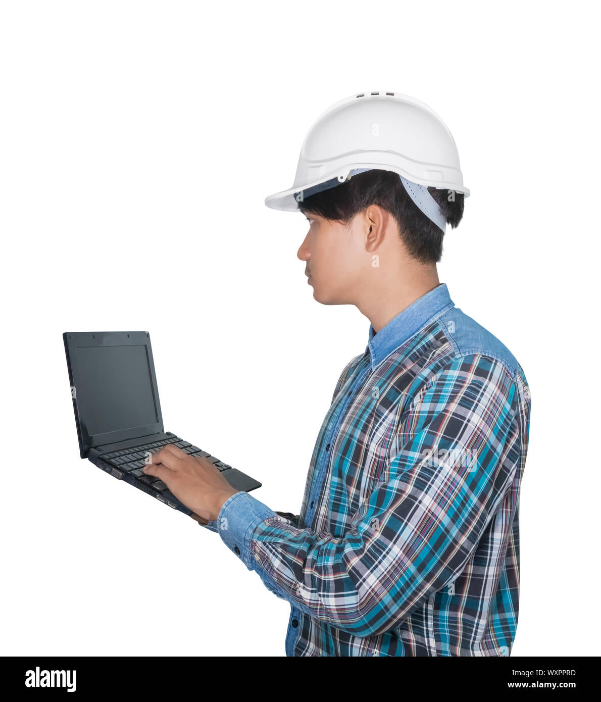 Engineer while holding using Laptop and head wear white safety helmet plastic . Concept Work construction on white background Stock Photo