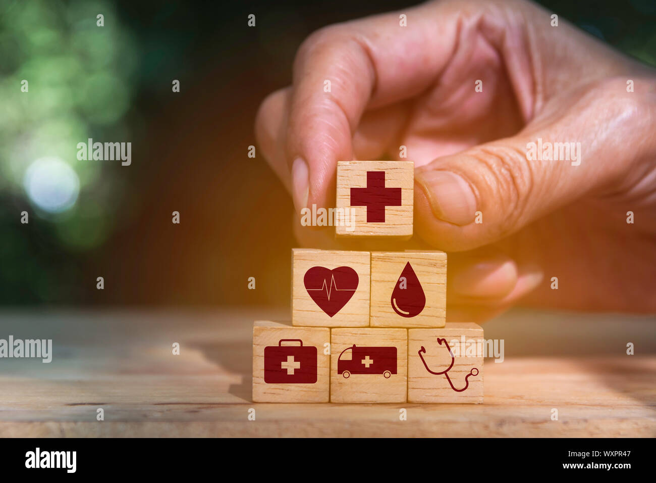 Hand holding cube dice health and medical symbols with copy space