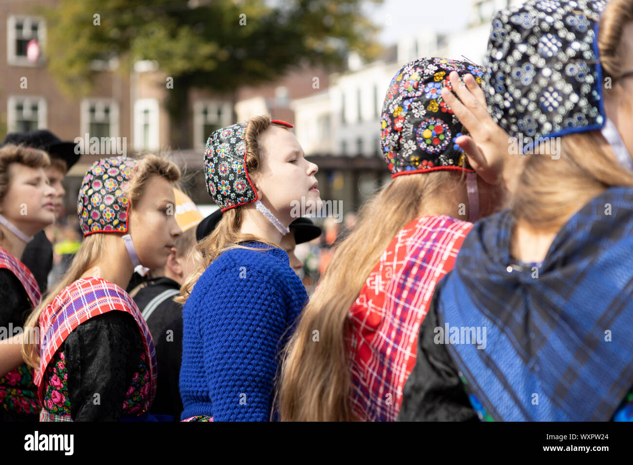 Young girls in traditional clothing waiting for the Dutch king and