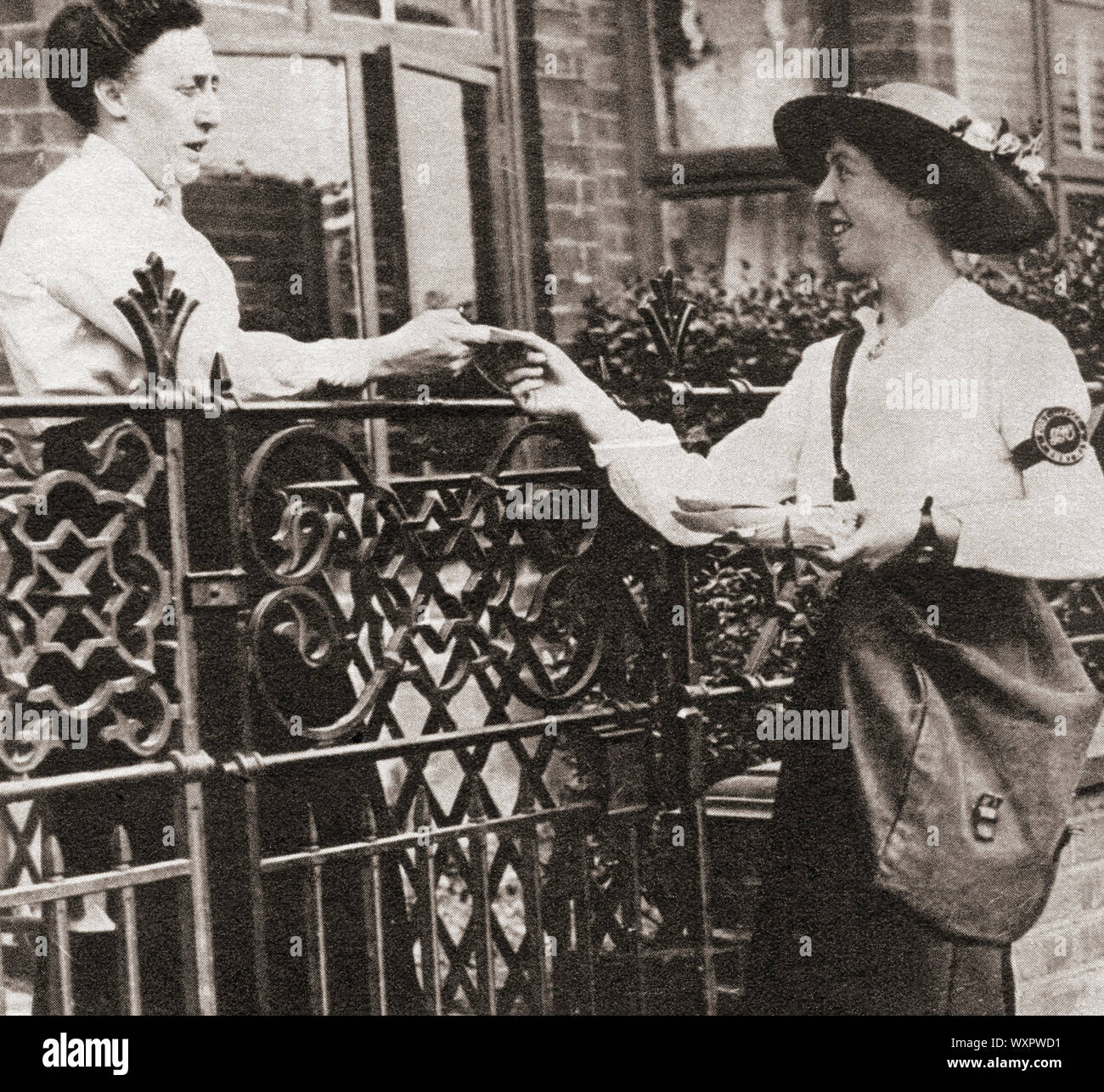 Postwomen delivering letters during World War One.  From The Pageant of the Century, published 1934. Stock Photo