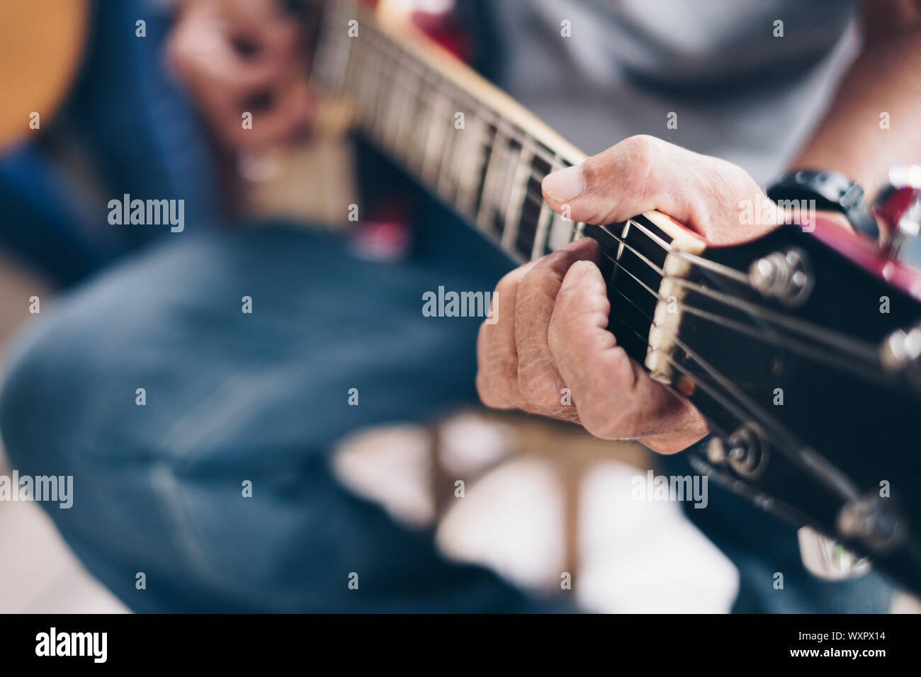 Man's hand the playing an electric guitar. Selective focus. Copy space. Stock Photo