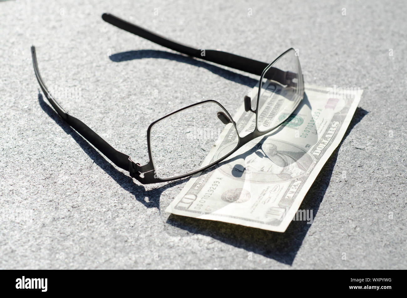 Banknote of Ten Dollar and Eyeglasses. Stock Photo