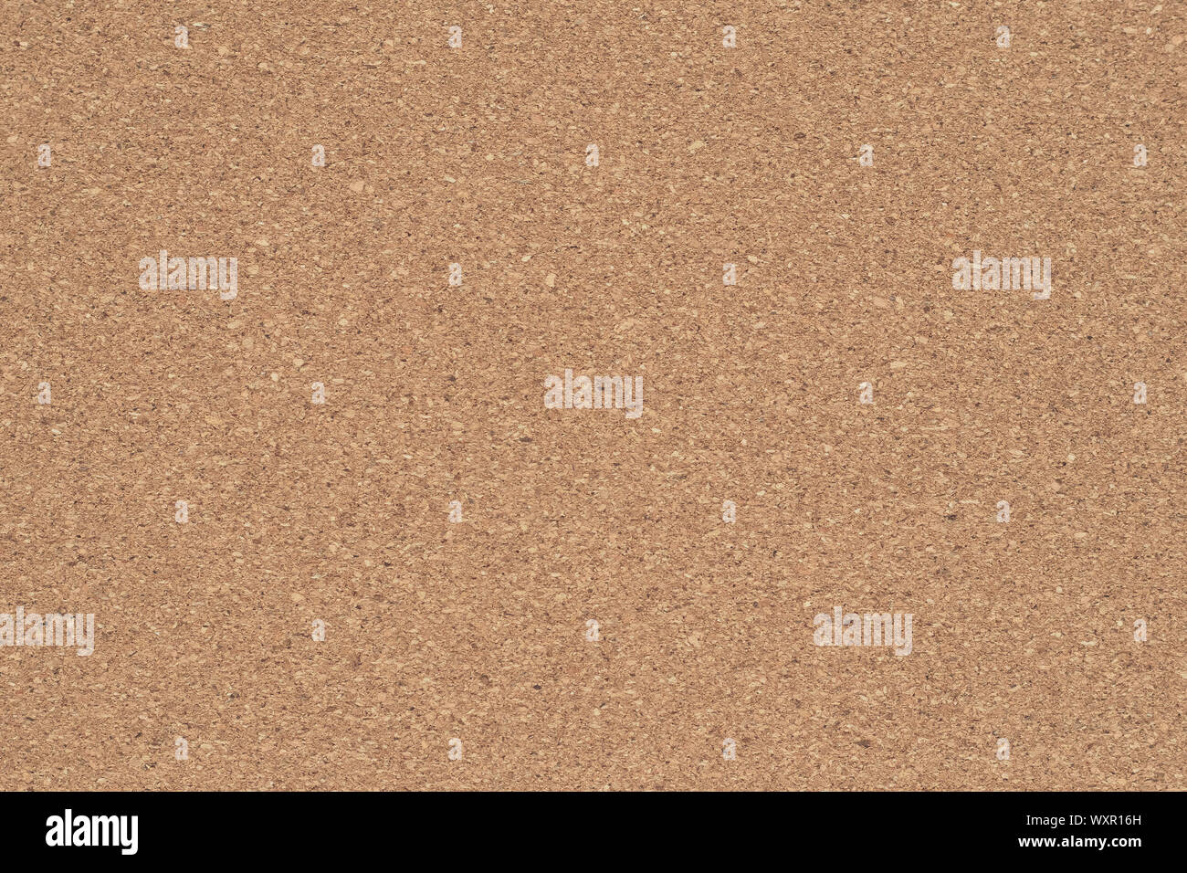 Corkboard background. Brown paper texture. Abstract pattern. Wood backdrop. Cardboard wall. Plywood. Stock Photo