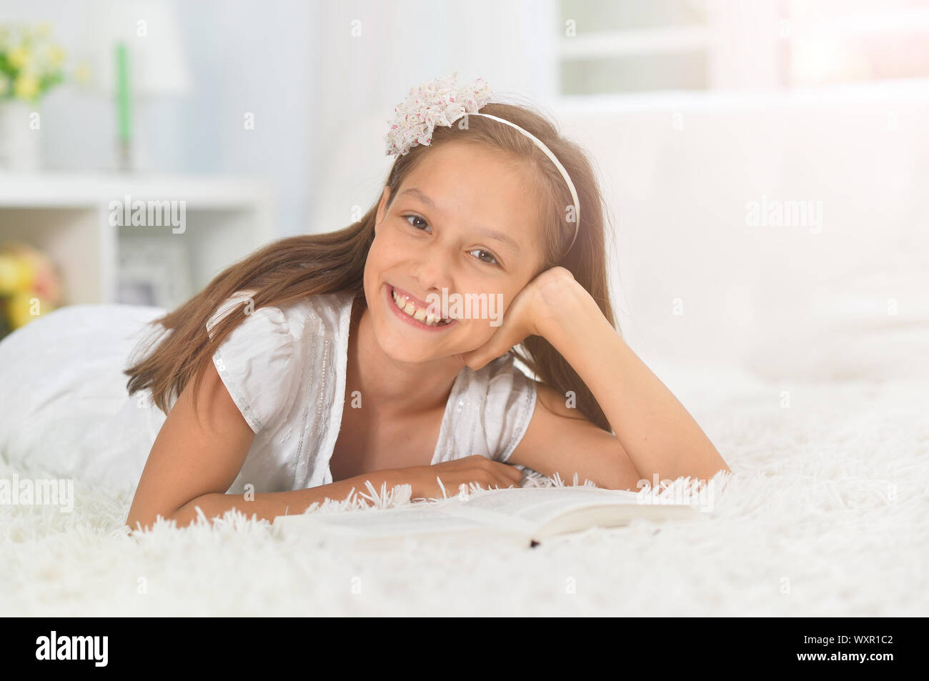 little cute girl reading book at home Stock Photo - Alamy