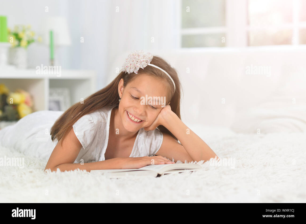 little cute girl reading book at home Stock Photo - Alamy
