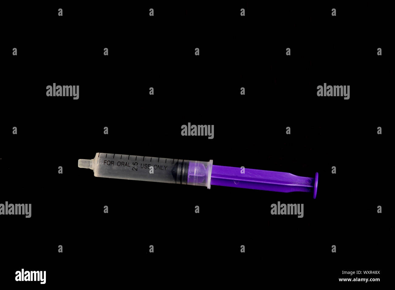 Medical dosage oral syringe for oral usage isolated on black background with copy space Stock Photo