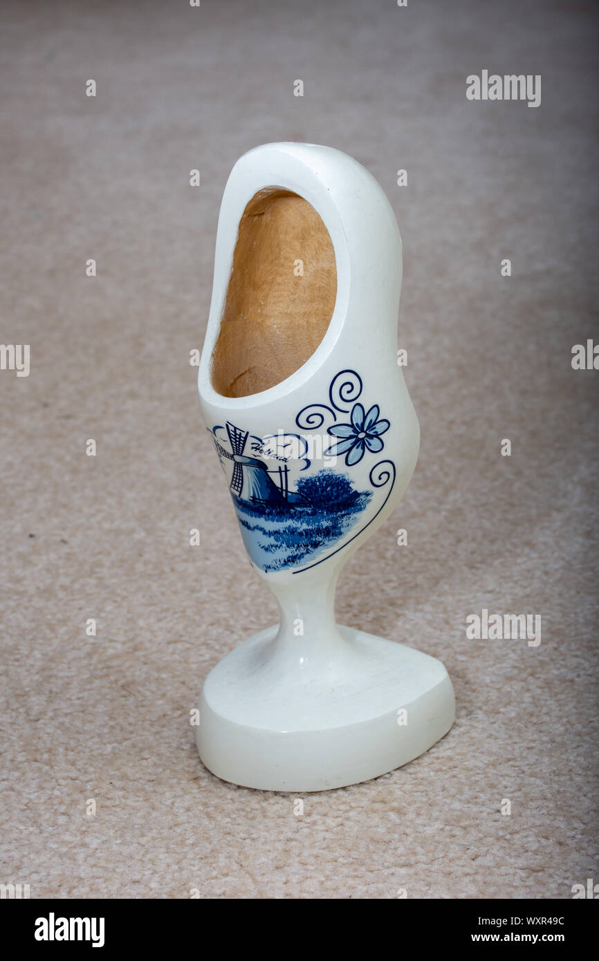 Delft Blue wooden shoe porcelain ornament.  Souvenir from Holland/Netherlands. Close up Isolated on beige background. Stock Photo