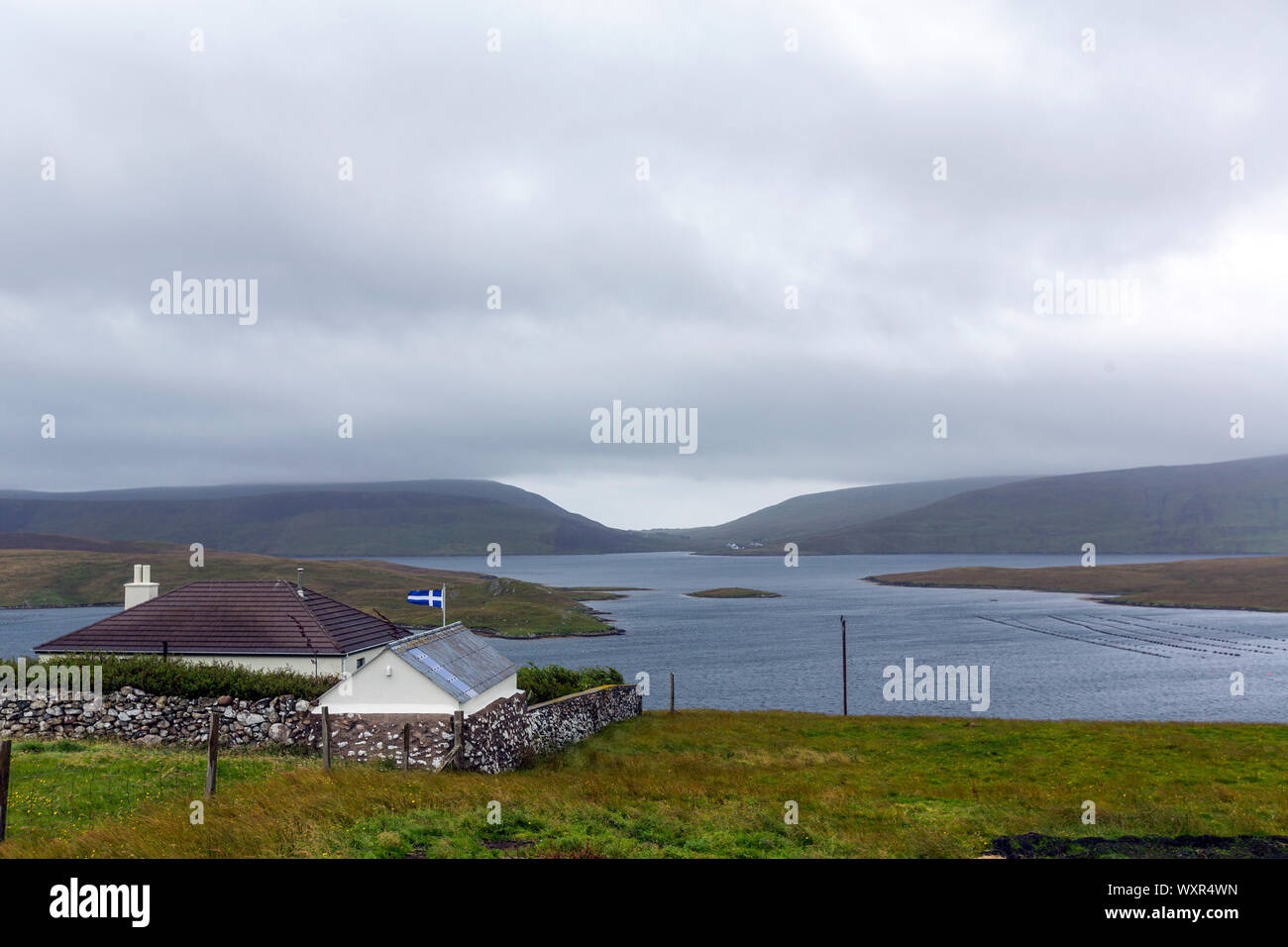 House with the Shetland flag in Hamnavoe, Mainland, Shetland islands, Scotland, UK Stock Photo