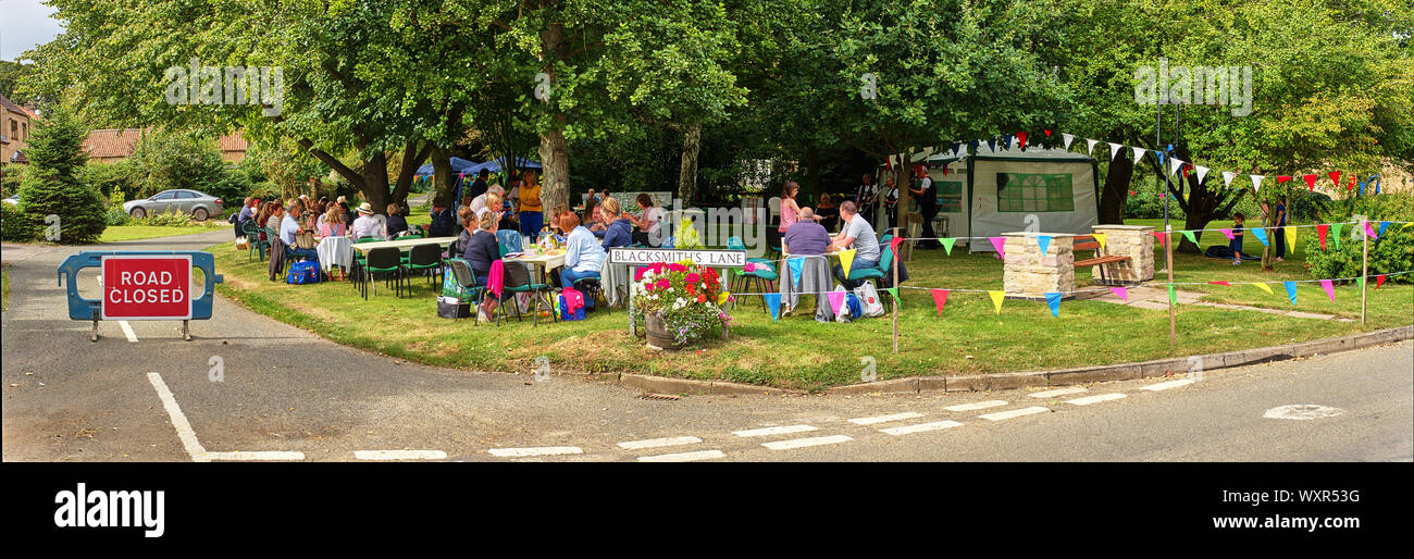 A panoramic view of a village street party / fete on the green in Welby, Lincolnshire, England. A well attended local community spirit event. Stock Photo