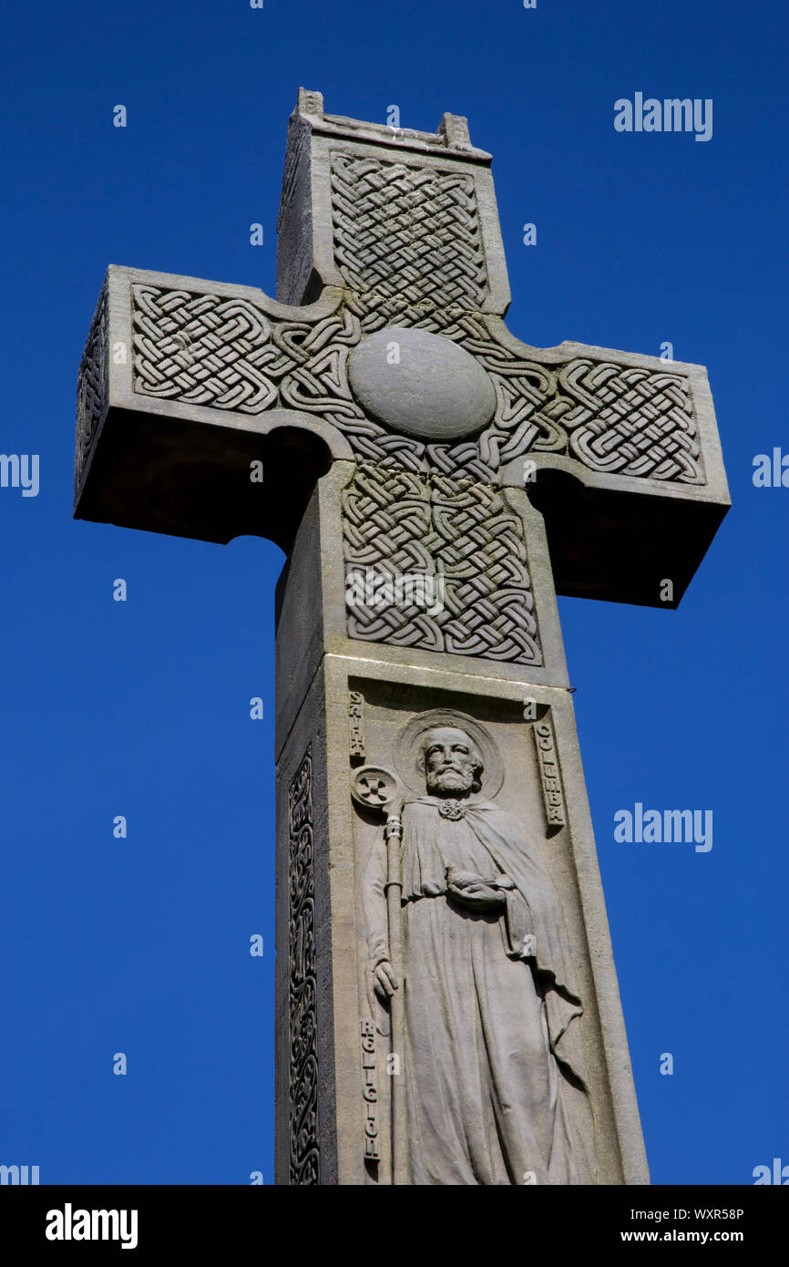 Large stone celtic cross isolated against a clear blue sky Stock Photo