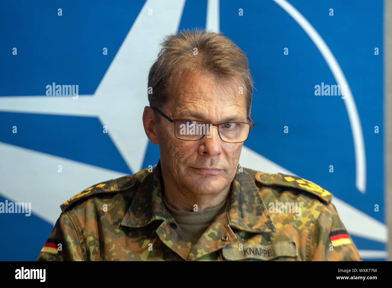 Ulm, Germany. 17th Sep, 2019. The commander of the Ulm command, Lieutenant General Jürgen Knappe, sits in front of the NATO logo. At a two-day meeting, representatives of the NATO States discussed the establishment of the NATO Joint Support and Enabling Command (JSEC). Credit: Stefan Puchner/dpa/Alamy Live News Stock Photo