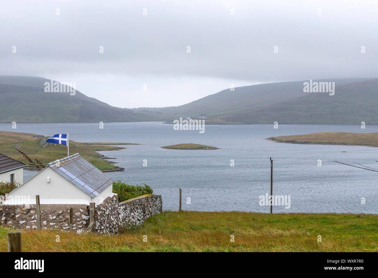 House with the Shetland flag in Hamnavoe, Mainland, Shetland islands, Scotland, UK Stock Photo
