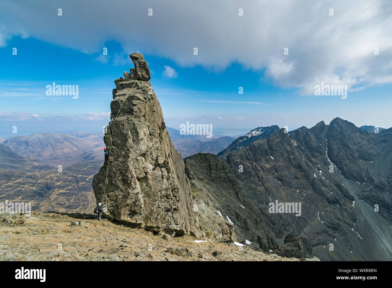 Climbers abseiling off the Inaccessible Pinnacle, at the summit of Sgurr Dearg, Cuillin mountains, Minginish, Isle of Skye, Scotland, UK Stock Photo