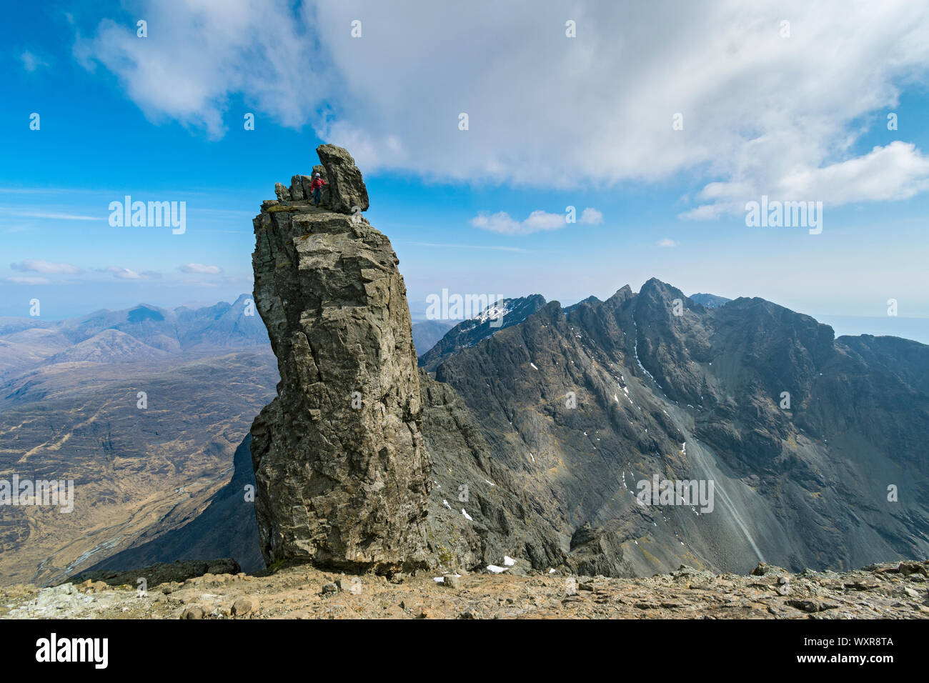 A climber at the top of the Inaccessible Pinnacle, at the summit of Sgurr Dearg, Cuillin mountains, Minginish, Isle of Skye, Scotland, UK Stock Photo