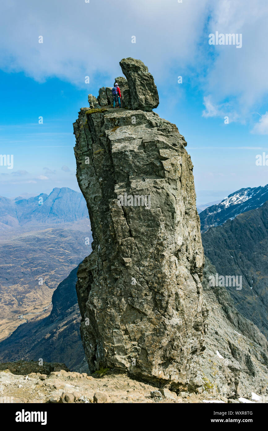 A climber at the top of the Inaccessible Pinnacle, at the summit of Sgurr Dearg, Cuillin mountains, Minginish, Isle of Skye, Scotland, UK Stock Photo