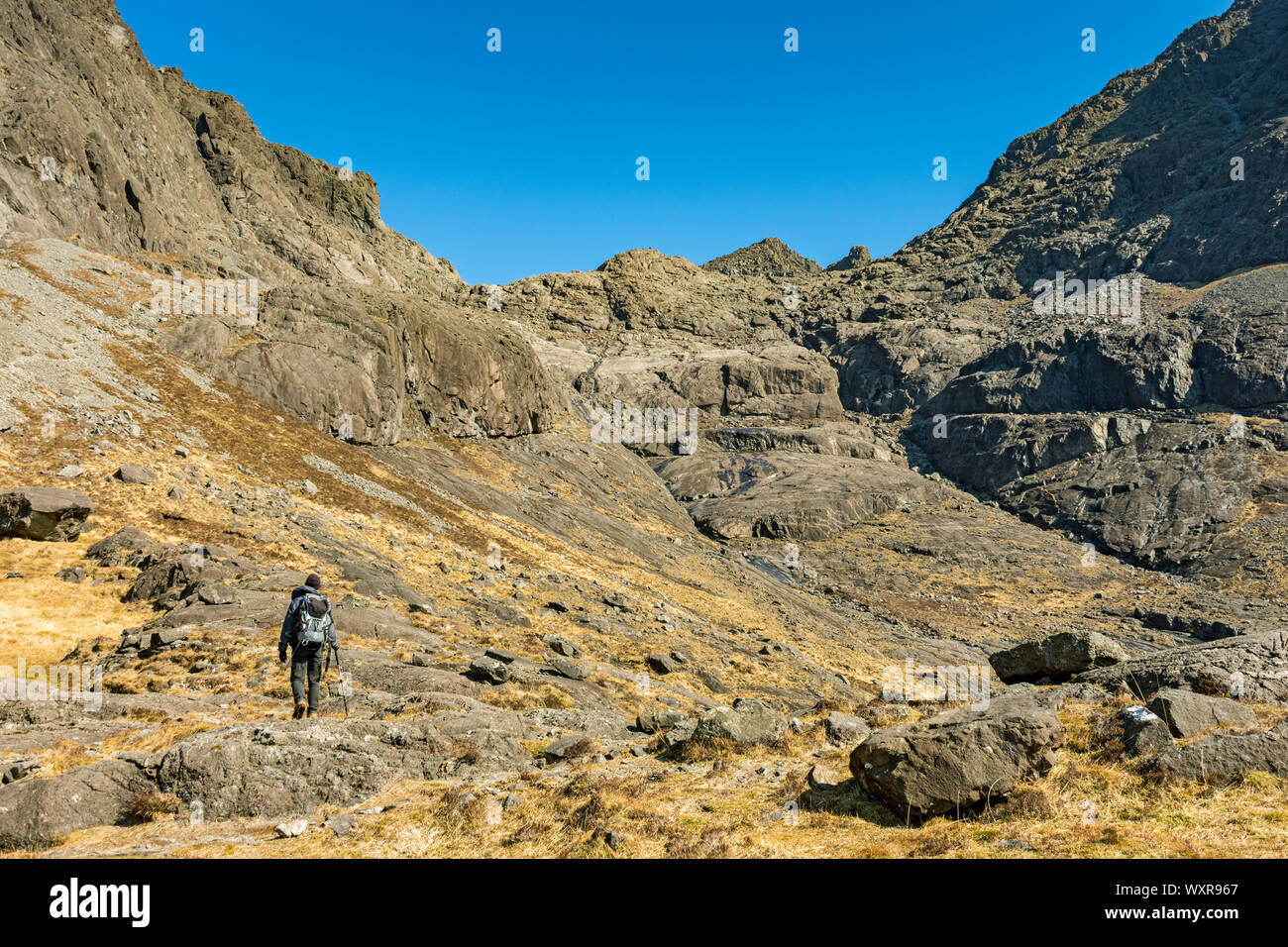 A walker heading into upper Coir' a'Ghrunnda, in the Cuillin mountains, Isle of Skye, Scotland, UK Stock Photo