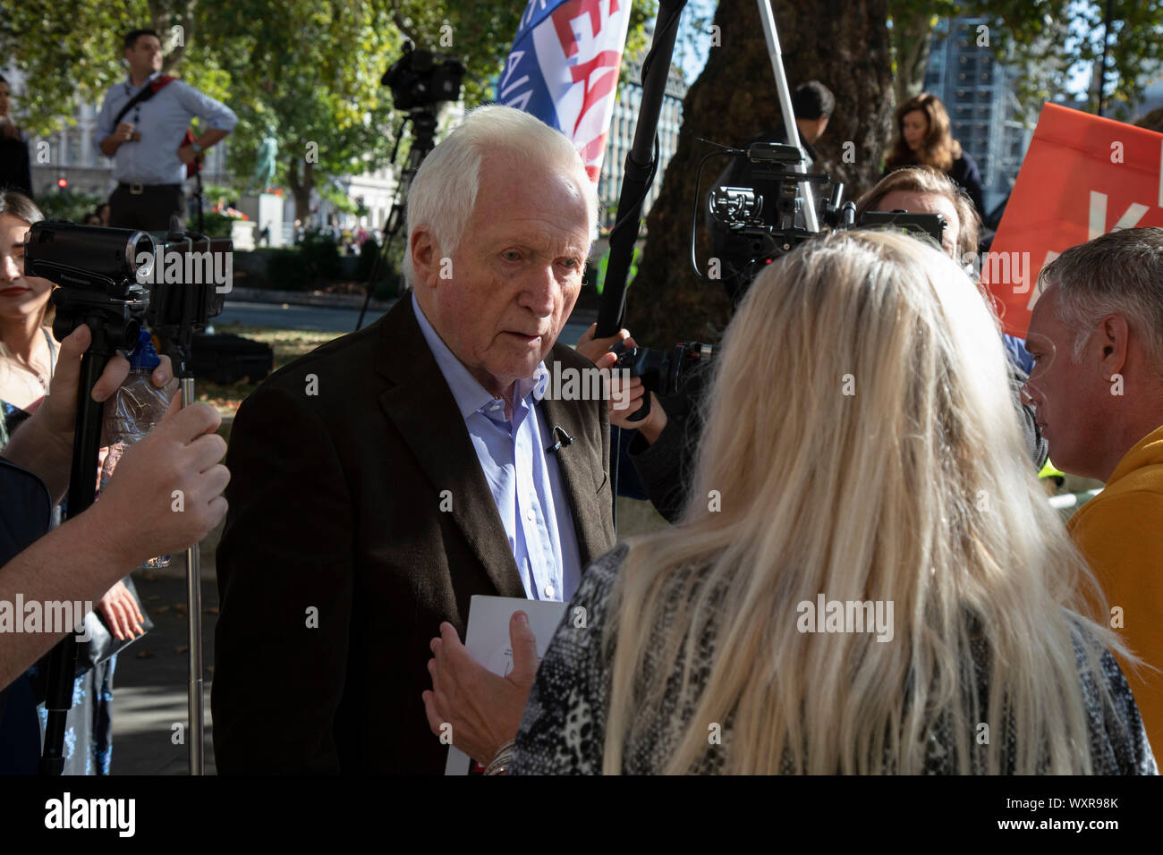 Television presenter and broadcaster David Dimbleby speaks to pro-leave protesters outside The Supreme Court as the first day of the hearing to rule on the legality of suspending or proroguing Parliament begins on September 17th 2019 in London, United Kingdom. The ruling will be made by 11 judges in the coming days to determine if the action of Prime Minister Boris Johnson to suspend parliament and his advice to do so given to the Queen was unlawful. David Dimbleby is a British journalist and former presenter of current affairs and political programmes, now best known for the BBCs long-running Stock Photo