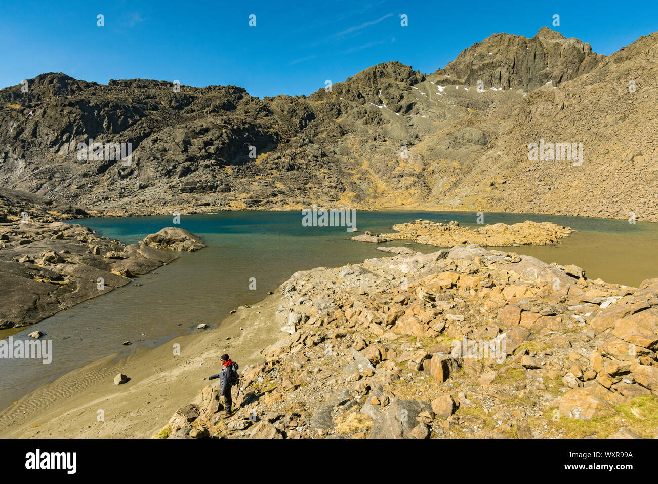 A walker by Loch Coir' a'Ghrunnda.  In the Cuillin mountains, Isle of Skye, Scotland, UK Stock Photo