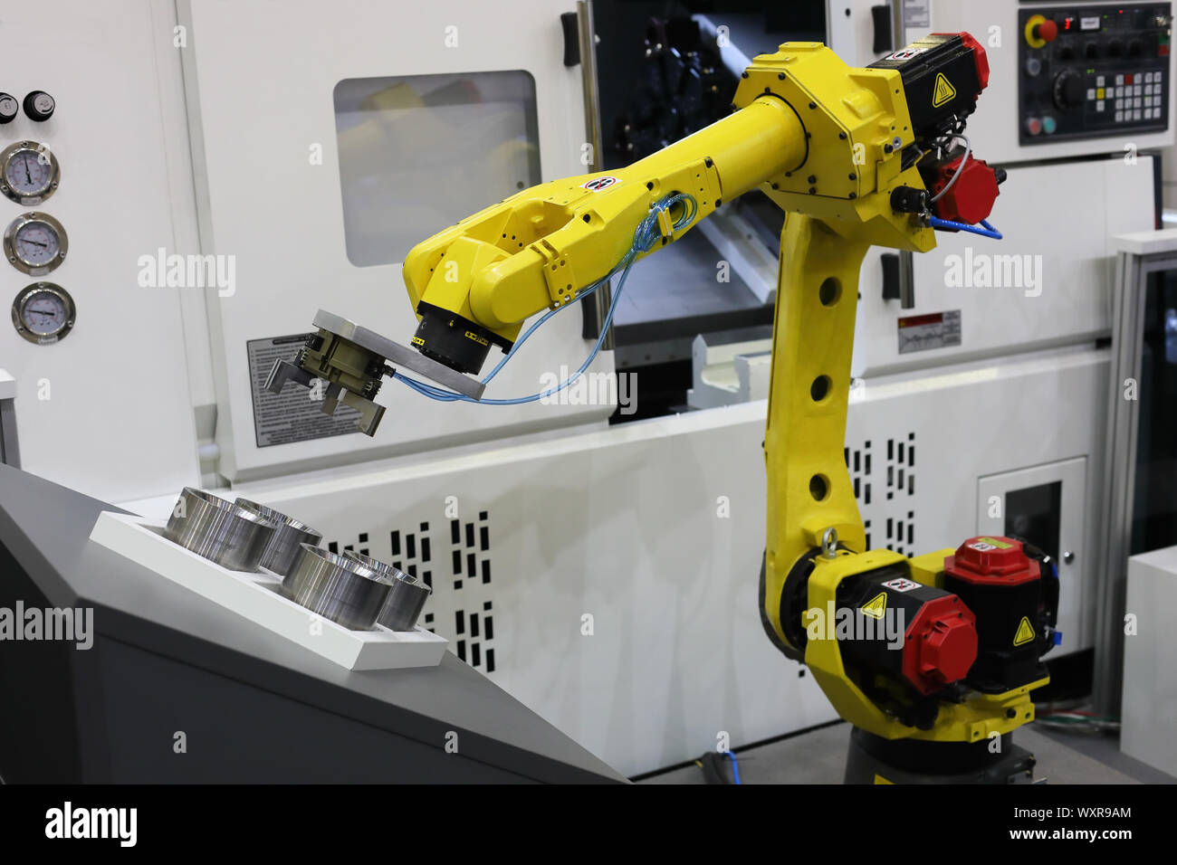 Automated CNC machine loading with robotic arm. Selective focus Stock Photo  - Alamy