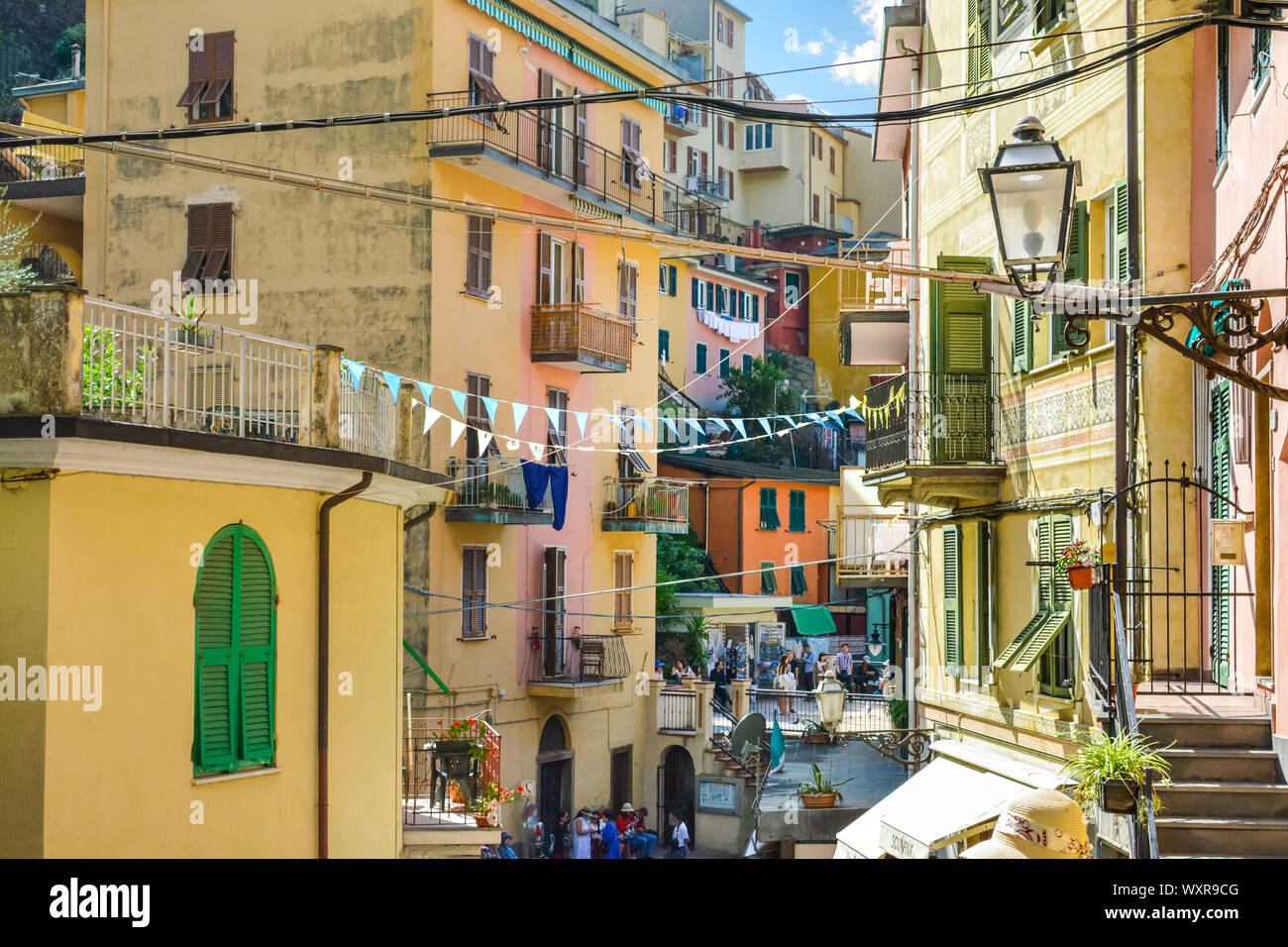 Apartments with balconies line the path through the colorful village of