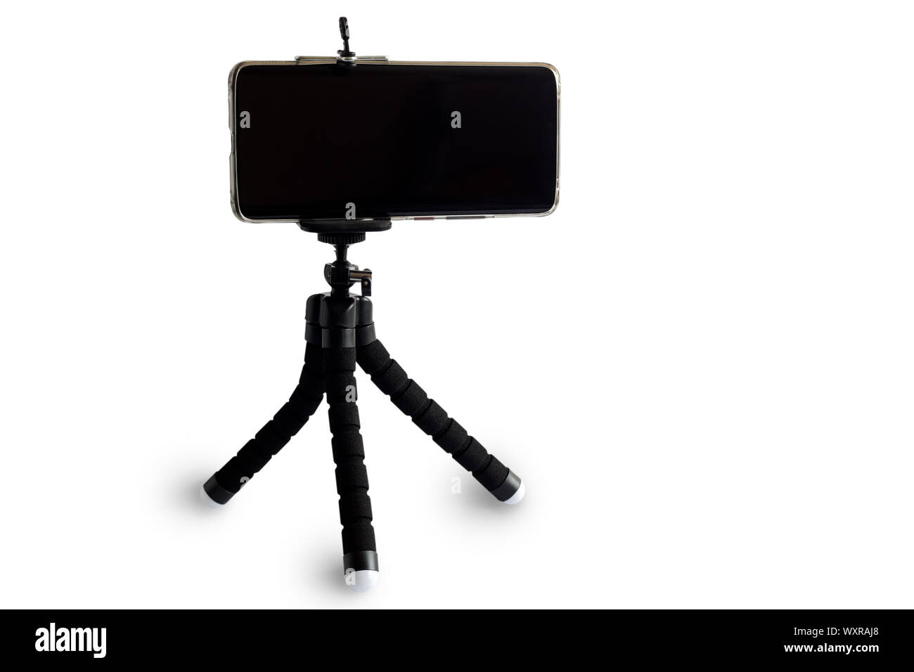 Smartphone and smartphone tripod on white background. Stock Photo