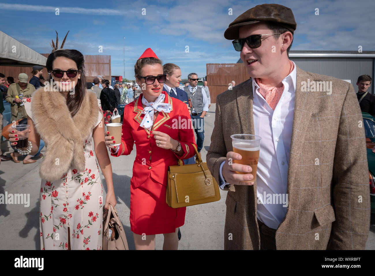 Vintage-themed fashion and other dress variations are worn during Goodwood Revival, Britain’s greatest annual classic car show, UK. Stock Photo