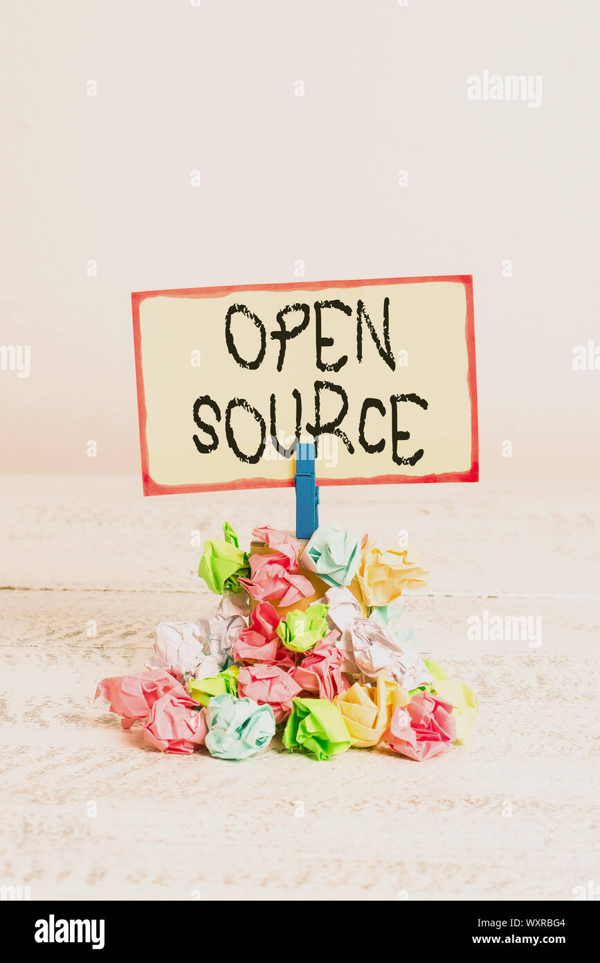 Writing note showing Open Source. Business concept for denoting software which original source code freely available Reminder pile colored crumpled pa Stock Photo