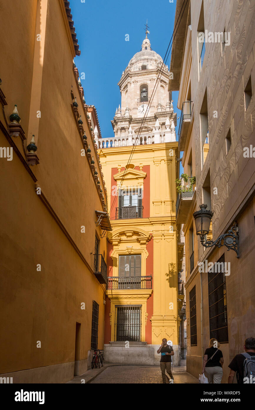 Malaga Cathedral, bell tower seen from a narrow street in Malaga, Andalucia, Spain. Stock Photo
