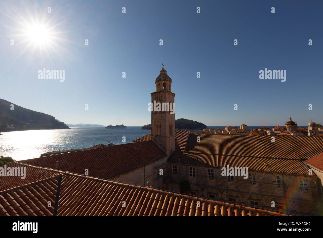 Dubrovnik old town; the belltower of the Domican Monastery and the morning summer sun seen from the city wall, Dubrovnik Croatia Europe Stock Photo