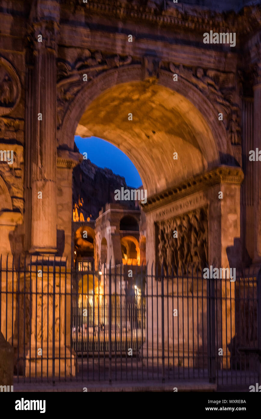 The Colosseum under the glow of lights at night, Rome Stock Photo