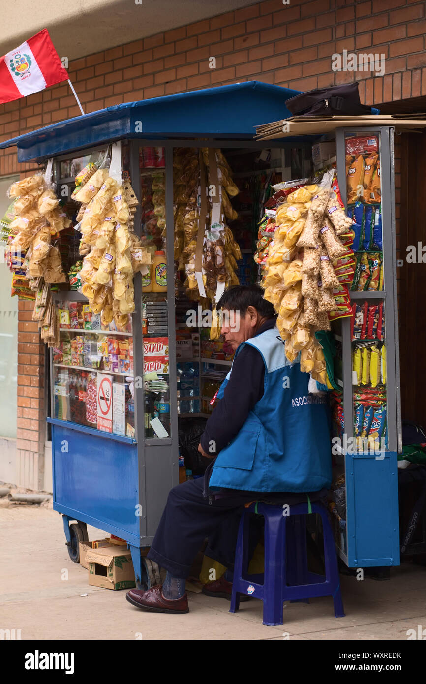 LIMA, PERU - JULY 23, 2013: Unidentified street vendor selling snacks and drinks at a stand on July 23, 2013 in Miraflores, Lima, Peru. Stock Photo