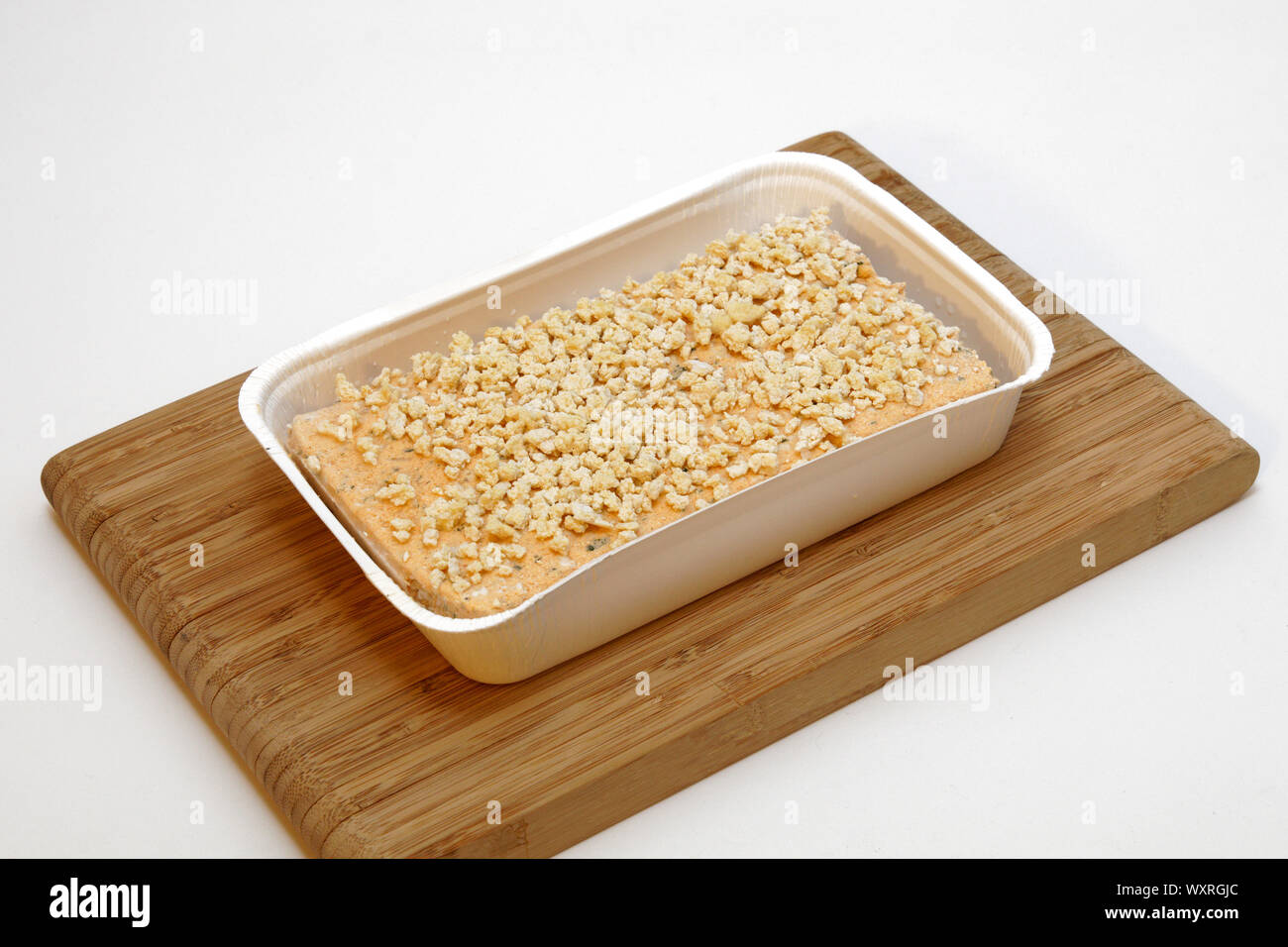 Frozen saithe fish fillet with herb crust Stock Photo - Alamy