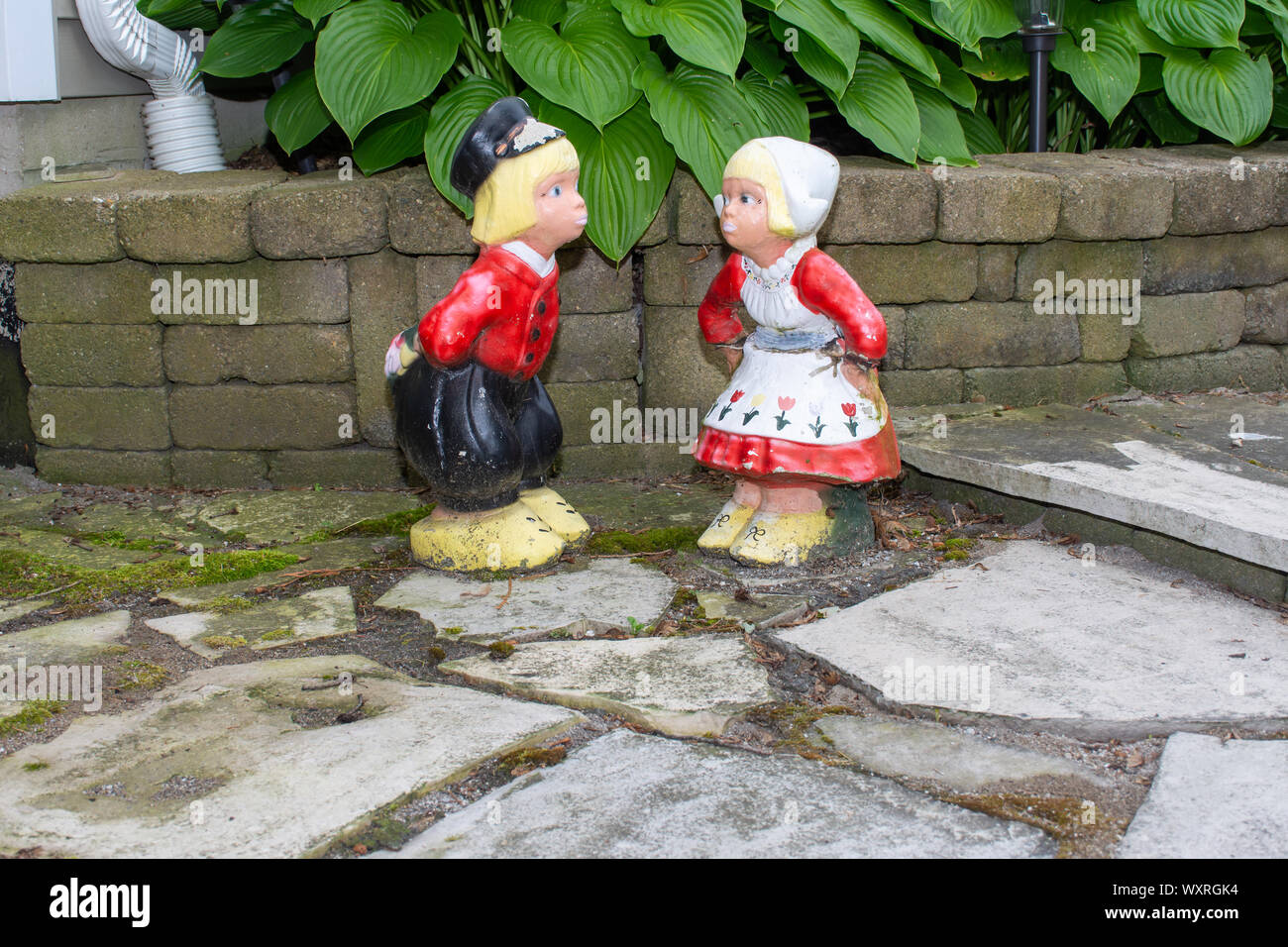 A Dutch Boy And Girl Lawn Ornaments Standing With Wooden Shoes And   A Dutch Boy And Girl Lawn Ornaments Standing With Wooden Shoes And Traditional Dutch Clothes From The Netherlands In Europe Wide Angle WXRGK4 