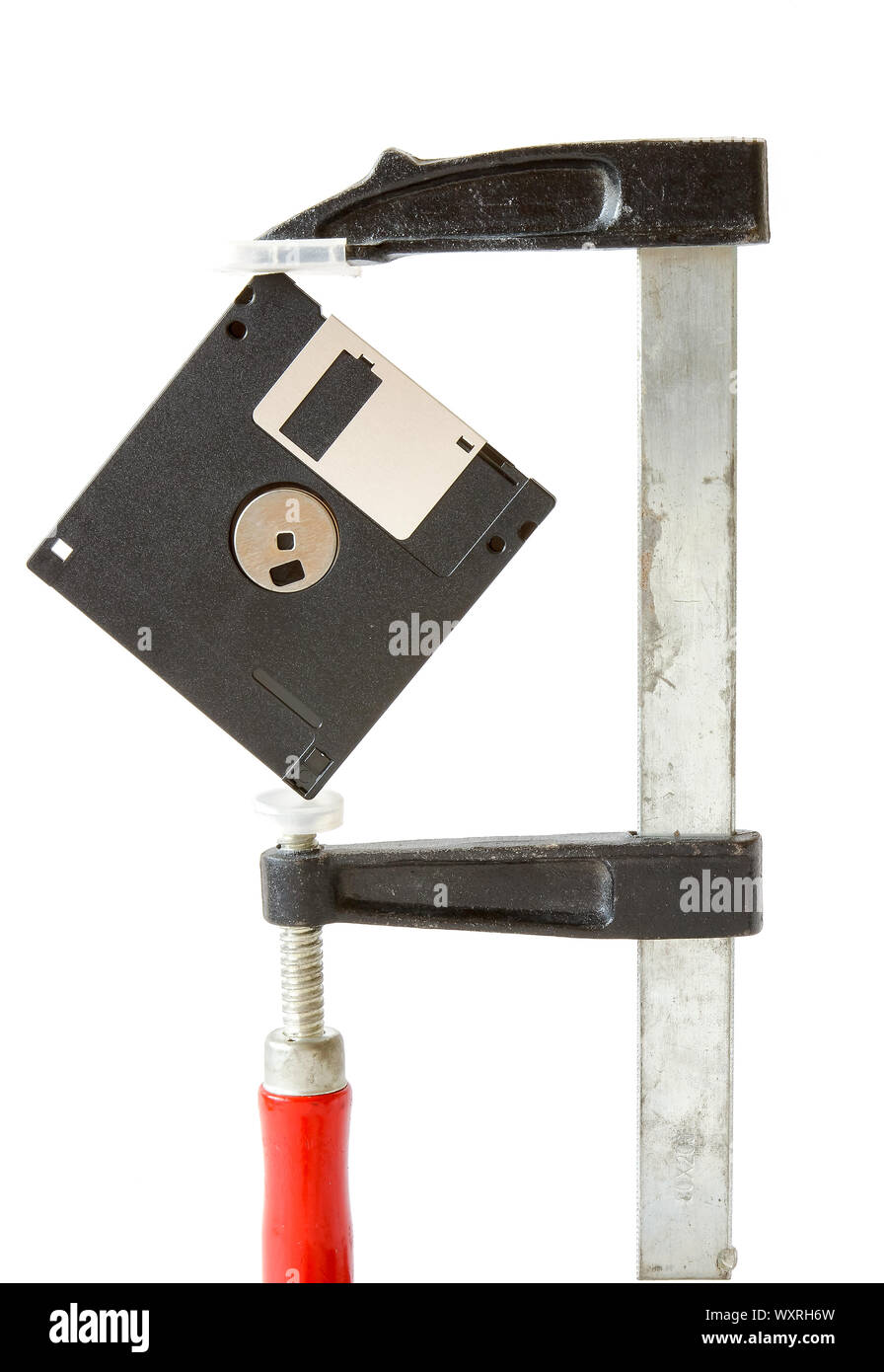 Diskette caught in carpentry clamps on a white background Stock Photo