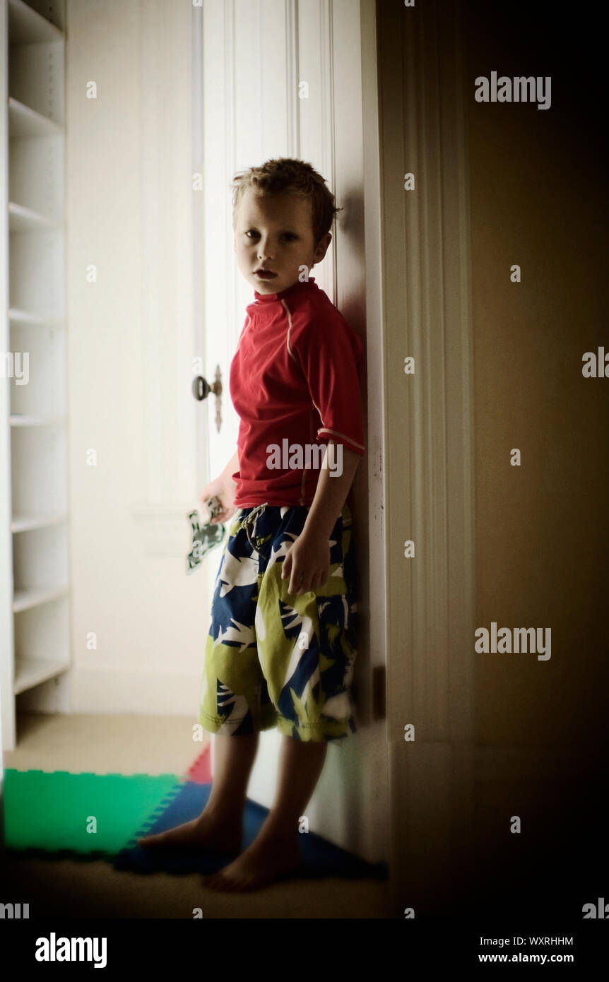 Boy standing in hallway Stock Photo Alamy