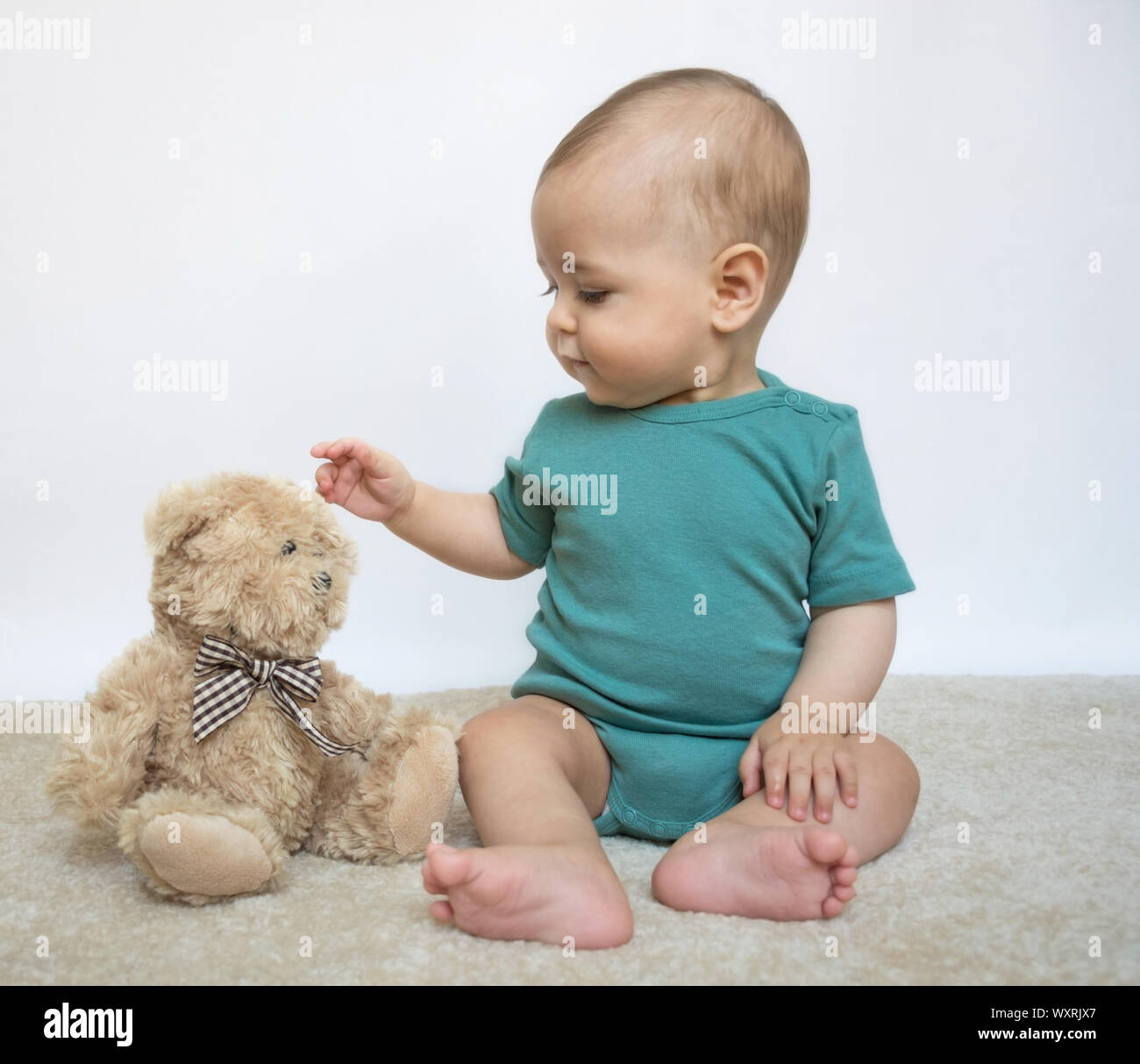 Sweet little baby boy with teddy bear on white background Stock Photo ...